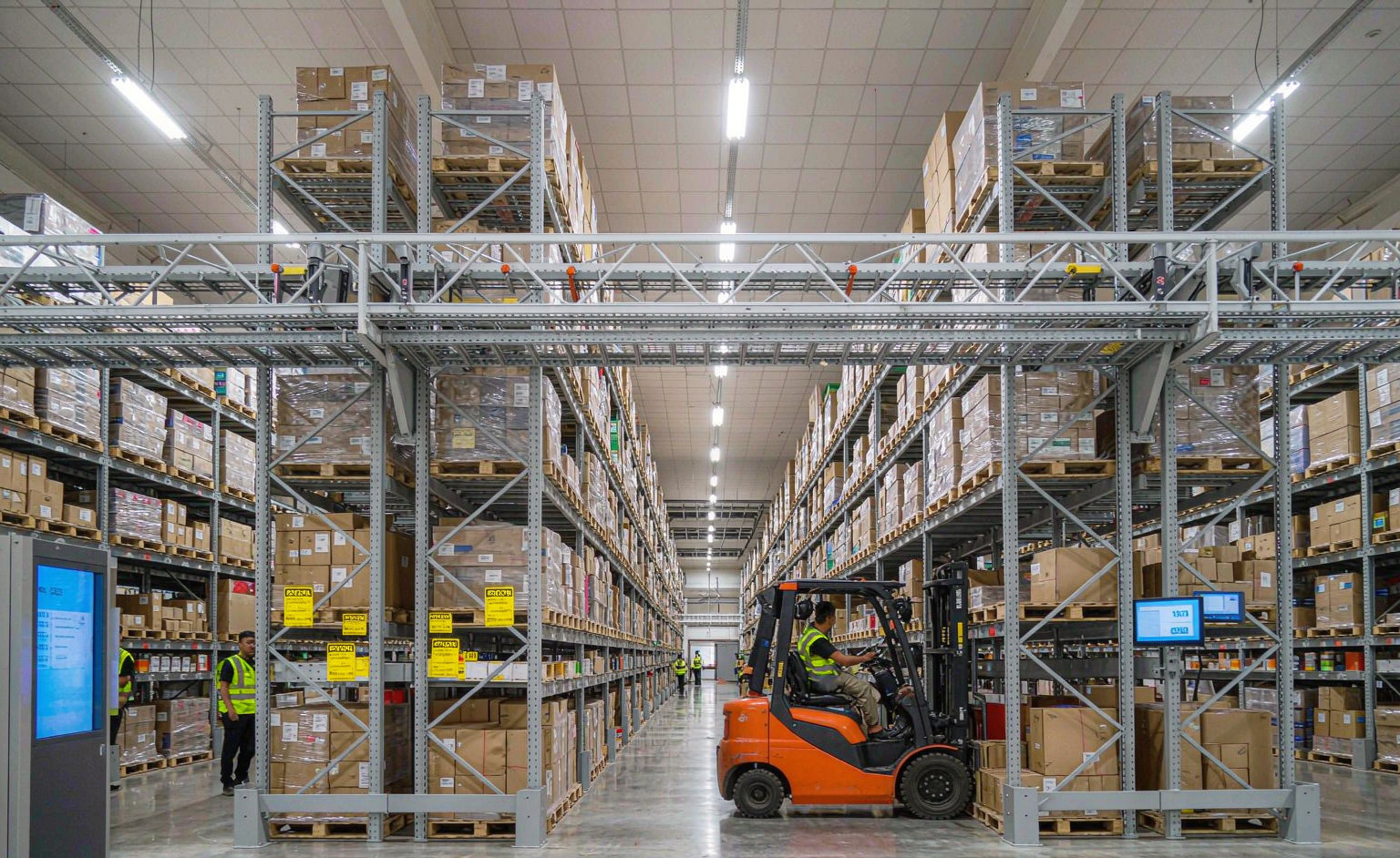 Modern logistics warehouse with organized storage racks and forklift